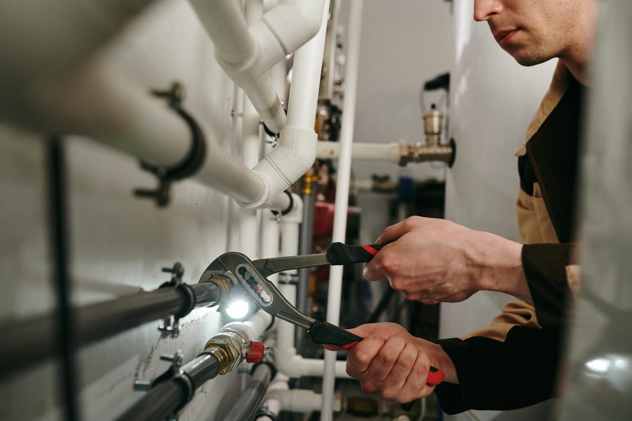 Plumbers maintaining commercial plumbing pipes in Battleground