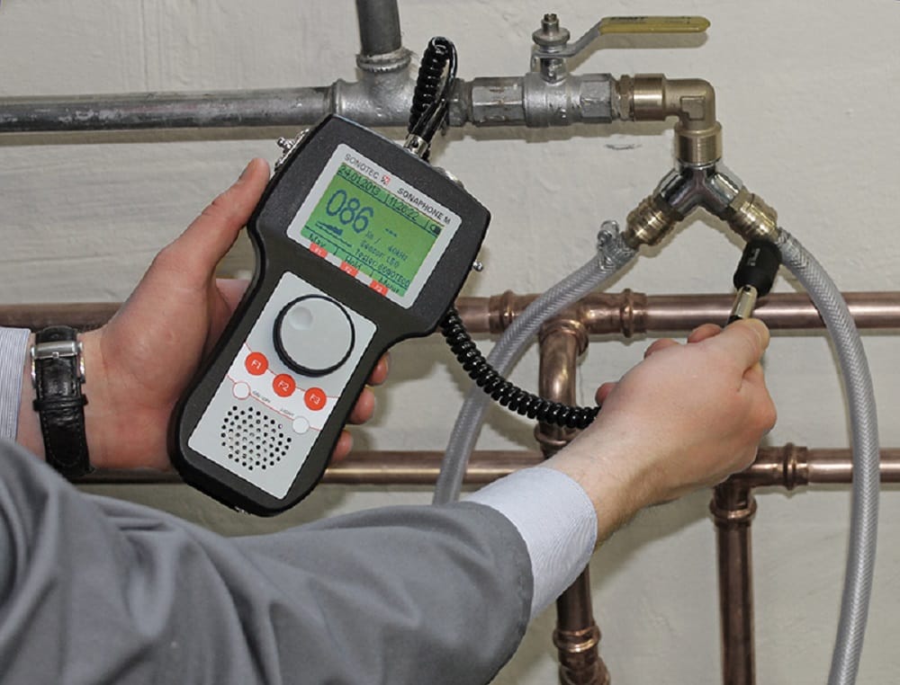 Plumber testing pipes with electronic leak detection equipment in Battleground