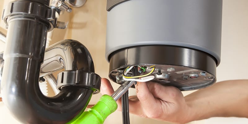 Technician repairing the heating element of a water heater in Battleground