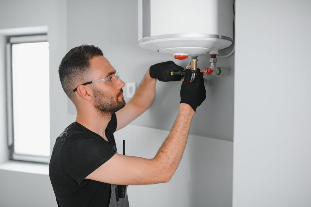 Technician performing water heater maintenance in Battleground