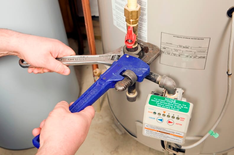 Plumber repairing a water heater valve in Battleground